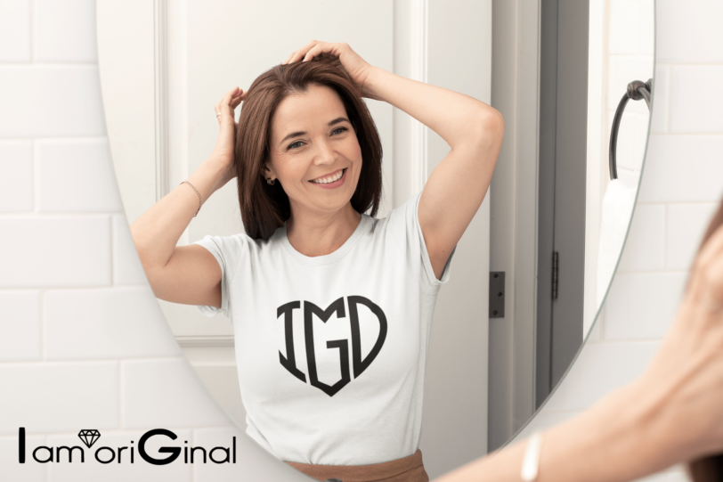 mockup of a happy middle aged woman wearing a t shirt and looking herself in the mirror 31607 1